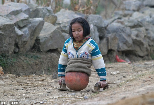 Qian Hongyan from Yunnan, pictured aged 10, lost her legs in 2000 after a car accident that nearly took her life