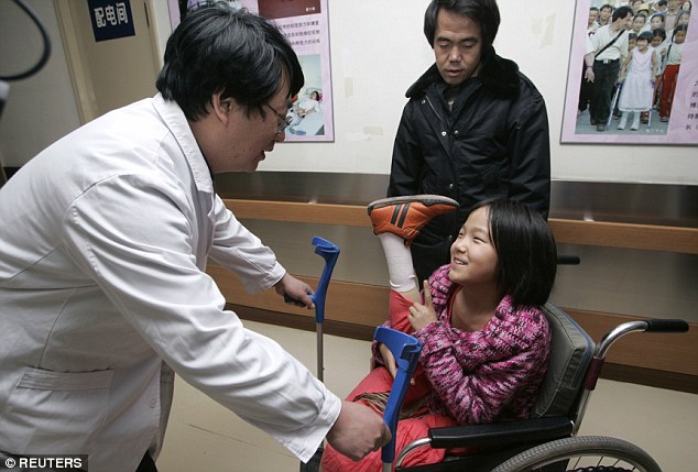 At 11, the girl talks to a doctor at China Rehabilitation Center in Beijing in 2007 after receiving her new legs