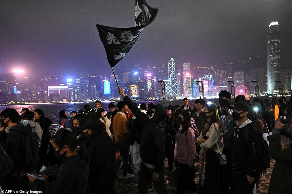Pro-democracy protesters take part in a march along the promenade of Tsim Sha Tsui district in Hong Kong to mark New Year