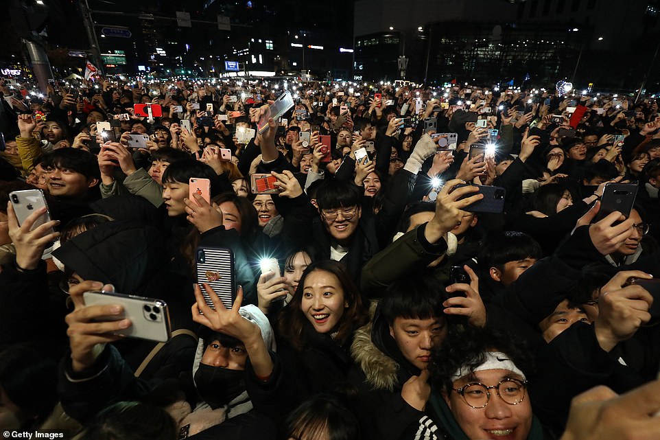 People gather to celebrate New Years at the Bosingak pavilion on January 1, 2020 in Seoul, South Korea