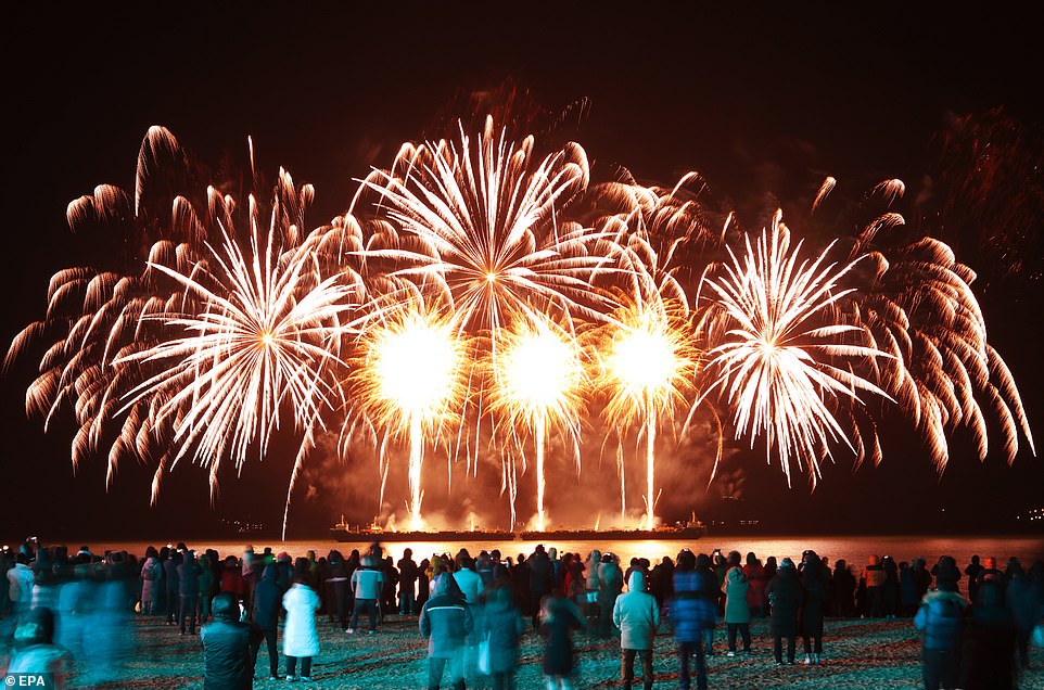 Residents and tourists watch the New Year's Eve fireworks show at Yulpo Beach in Yulpo, South Korea