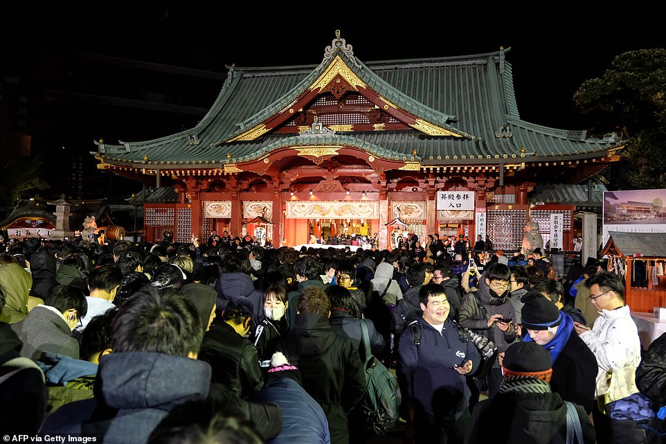 People visit Kanda Myojin Shrine to offer New Year prayers for the health and wealth of their families in Tokyo
