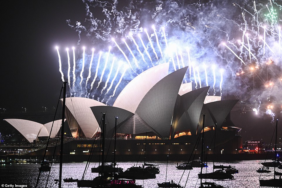 Fireworks explode over the Sydney Harbour Bridge and the Sydney Opera House