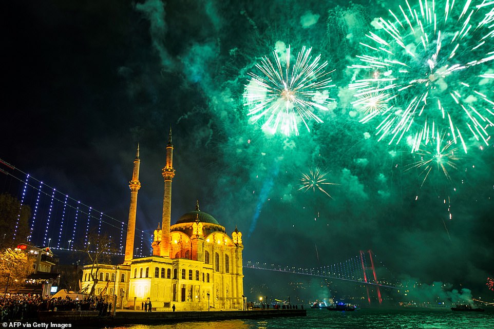 Fireworks explode in the sky over the Ortakoy Mosque by the July 15 Martyrs' Bridge during the New Year's celebrations, in Istanbul on January 1, 2020