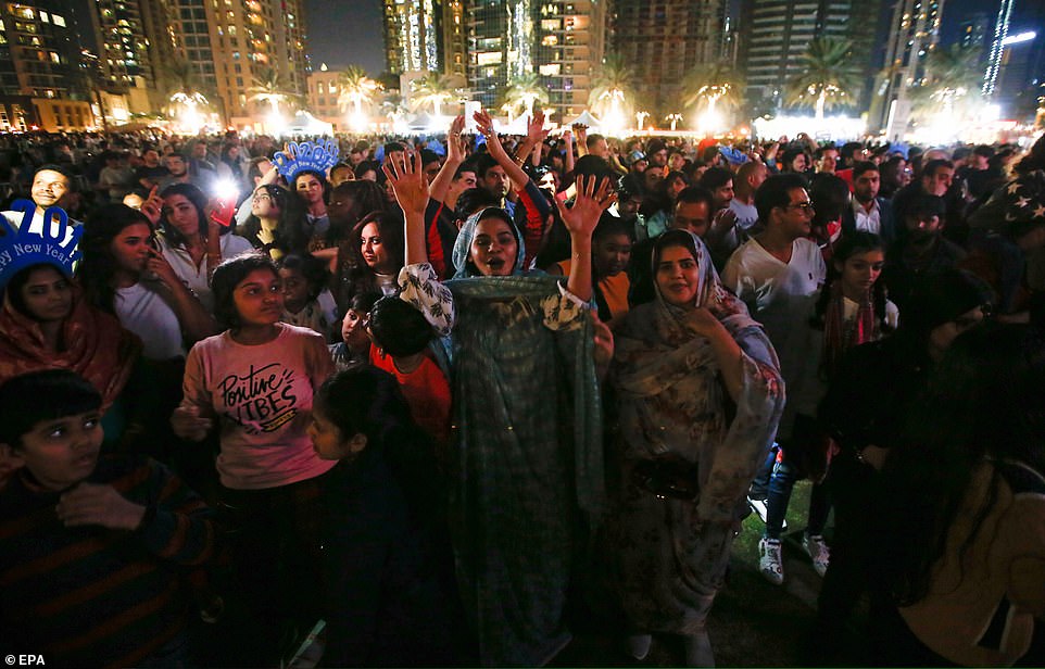 People gather near to Burj Khalifa, the tallest building in the world, prior to the fireworks of New Year's eve 2020 in the Gulf emirate of Dubai, United Arab Emirates, 31 December 2019