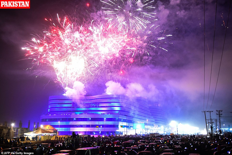 People watch fireworks as part of the New Year celebrations in Rawalpindi on January 1, 2020