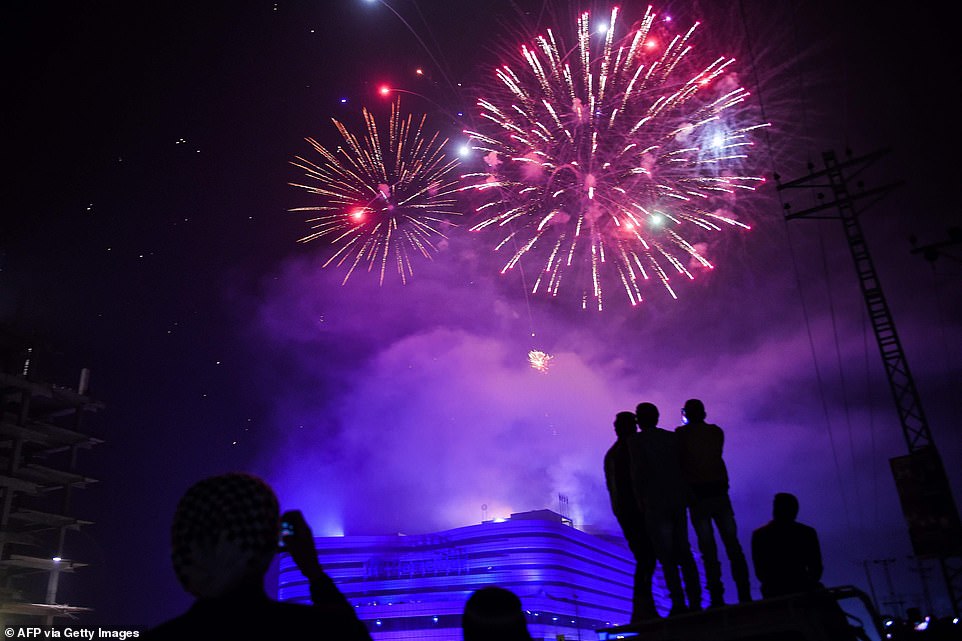 People watch fireworks as part of the New Year celebrations in Rawalpindi on January 1, 2020