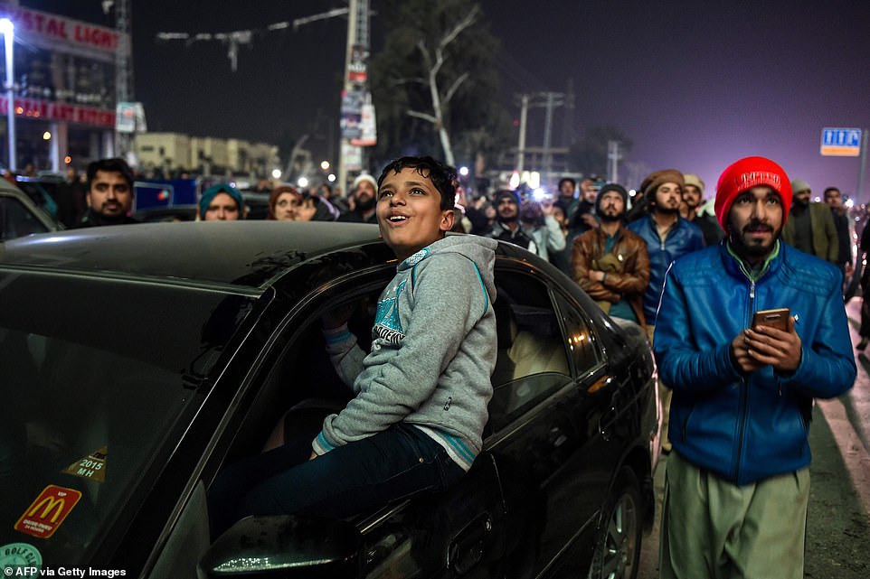 People watch fireworks as part of the New Year celebrations in Rawalpindi on January 1, 2020