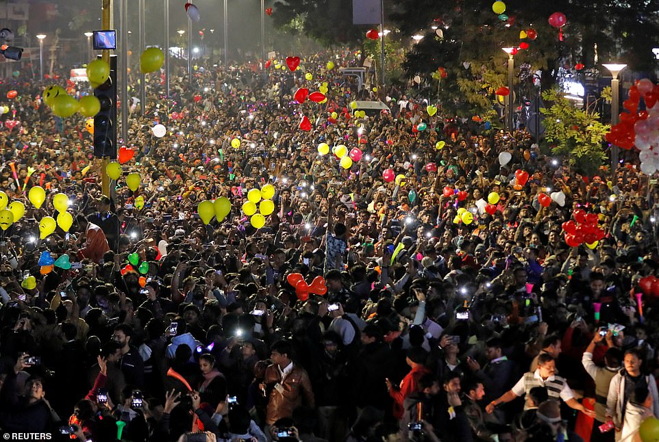 People release balloons as they celebrate the New Year's countdown event in a road in Ahmedabad, India, January 1, 2020