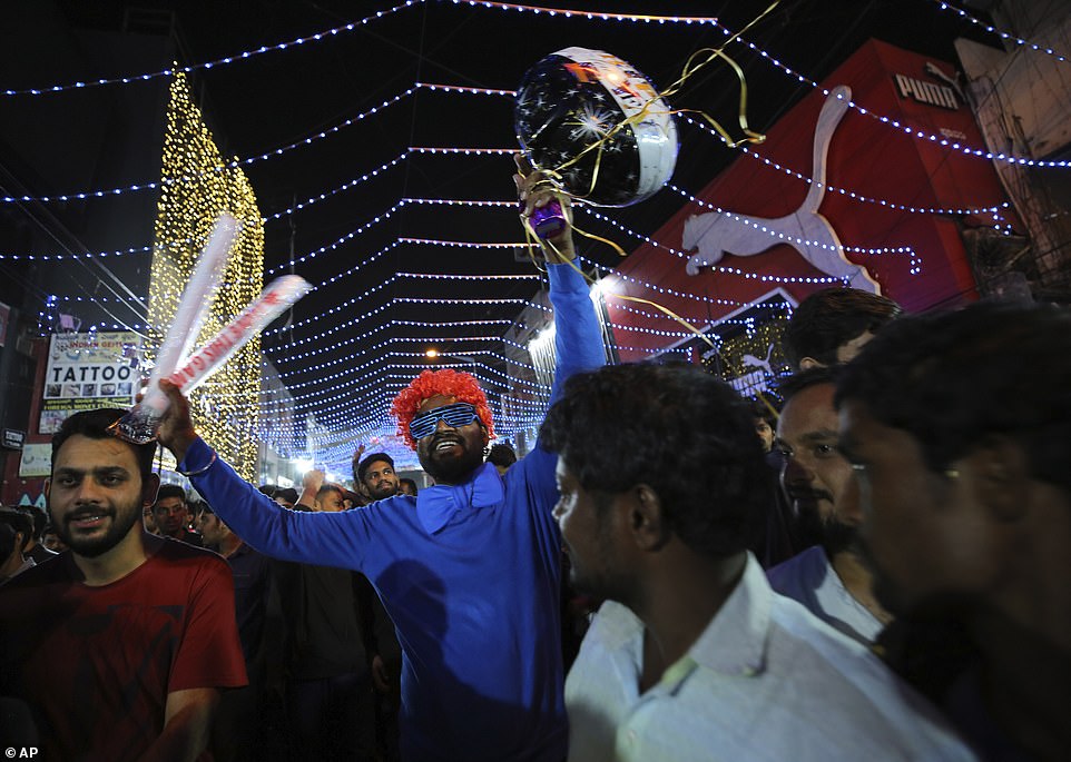 Revelers get together to celebrate on New Year's eve in Bangalore, India, Tuesday, Dec. 31, 2019