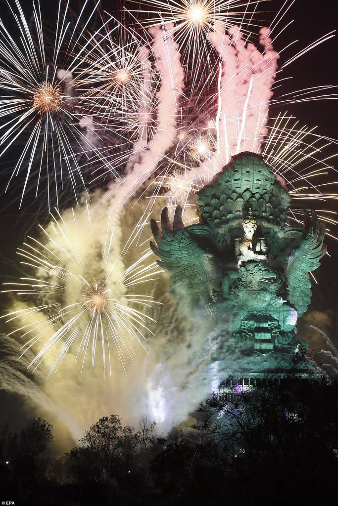 Fireworks explode after midnight over Garuda Wisnu Kencana cultural park part of New Year celebrations in Bali, Indonesia