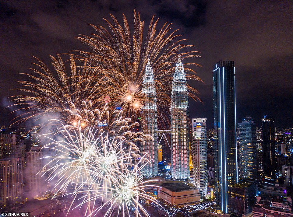 New Year fireworks light up the night sky around the Petronas Twin Towers during celebrations in Kuala Lumpur, Malaysia