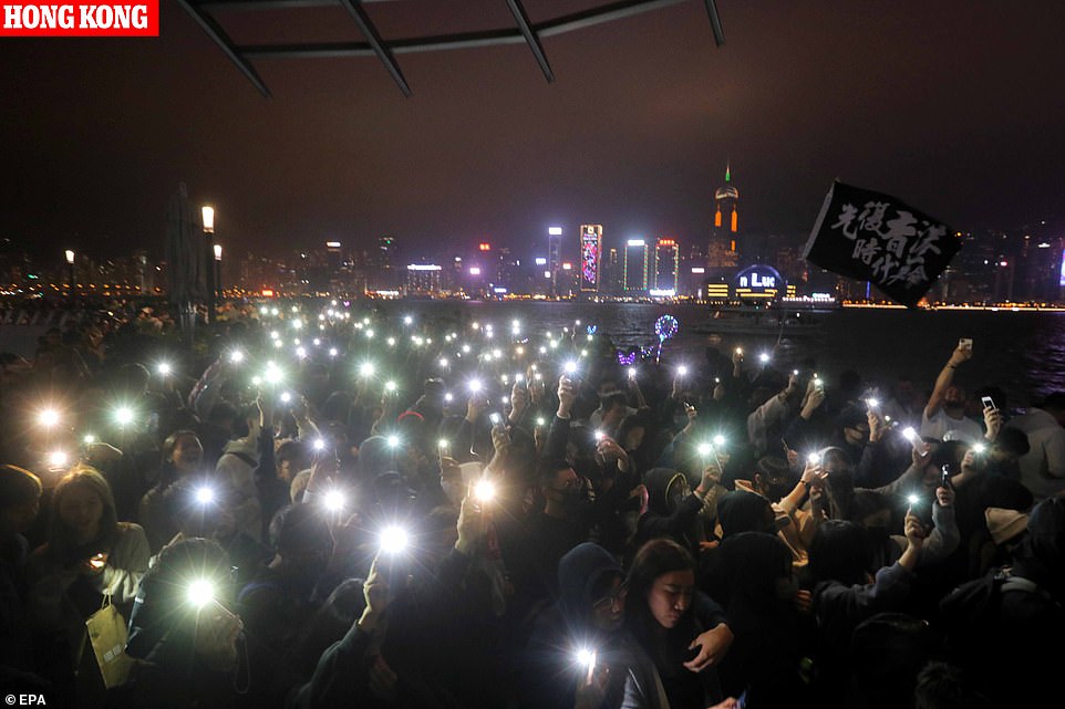 Hong Kong pro-democracy activists stage a demonstration as the clock strikes midnight on New Year's Eve, after a year of political upheaval in the Chinese administered region